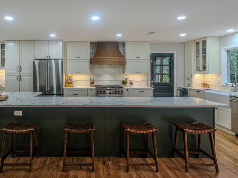 Modern kitchen renovation with a large Quartz island, stainless steel appliances, and custom cabinetry.