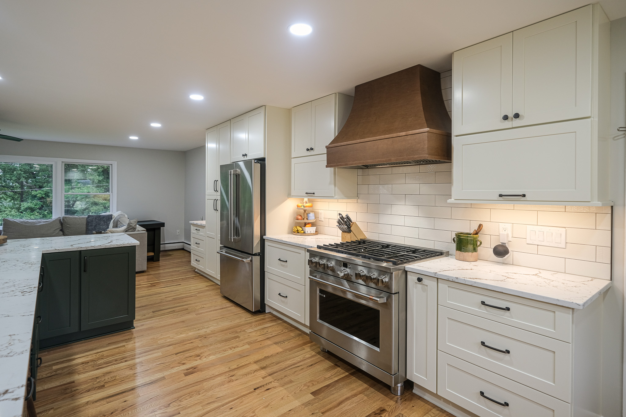 Kitchen range with a wood range hood, stainless steel oven, and ample cabinet space.