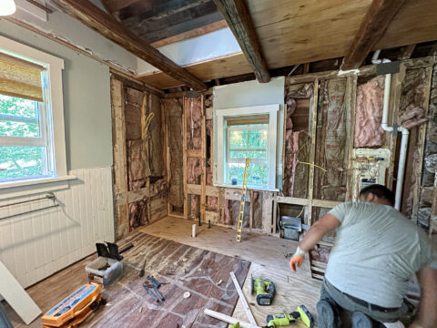 Partially renovated bathroom with insulation exposed, under construction