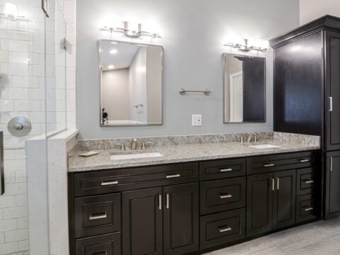 double vanity with quartz countertop and mirrors.