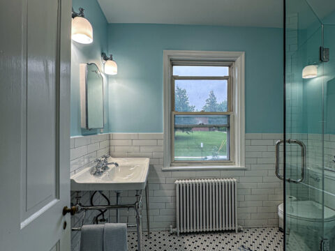 Classic Black and White Mosaic Tile Bathroom with Large Window and Chrome Details