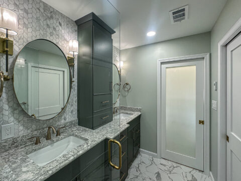 Polished Quartz Double Vanity with Brass Fixtures and Custom Cabinetry