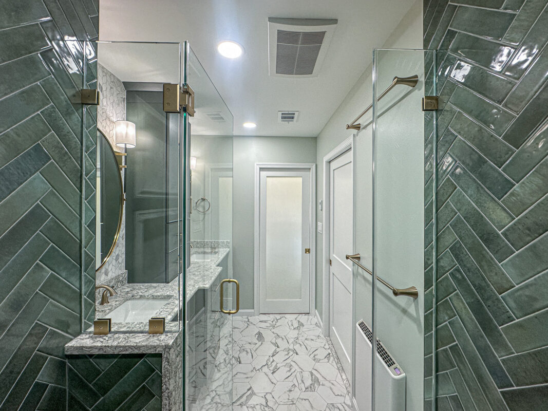 Spa-Inspired Bathroom Entrance with Hex Tile Floor and Frameless Shower