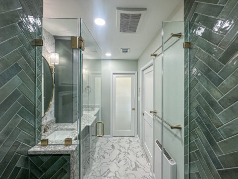 Spa-Inspired Bathroom Entrance with Hex Tile Floor and Frameless Shower